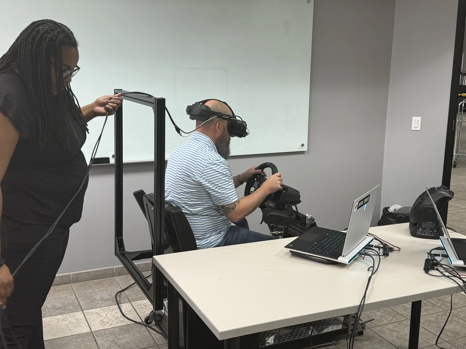 Instructor working with an operator on a Classroom Standard simulator