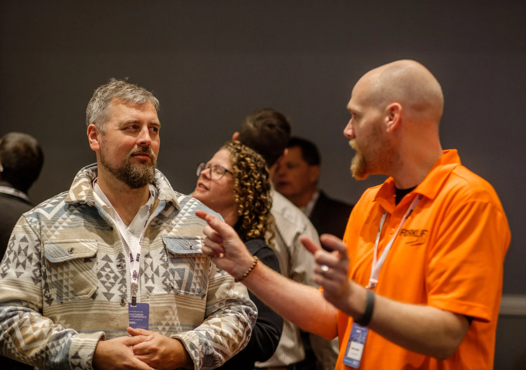 A conversation at the Virtual Forklift demonstration area.